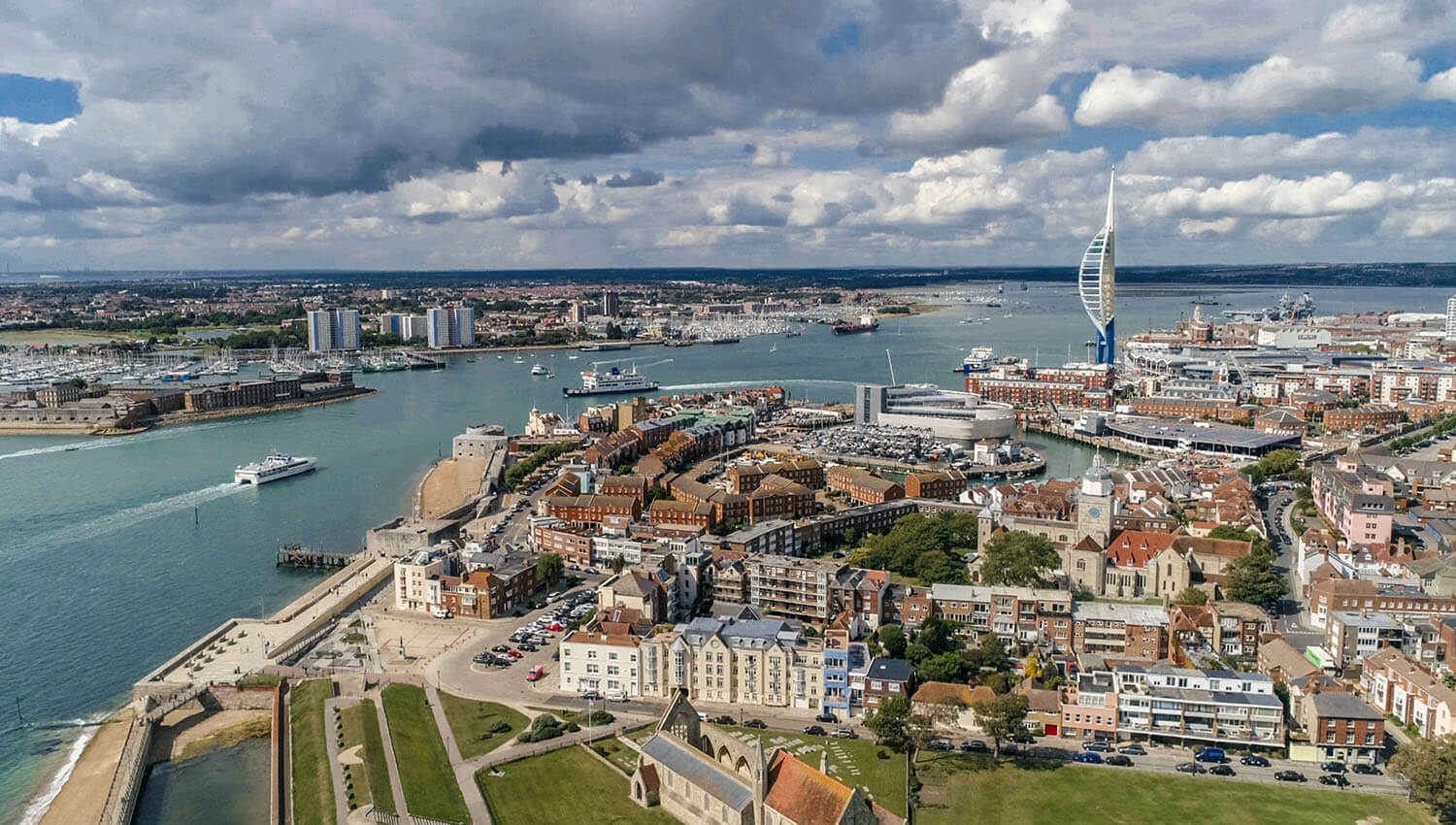 portsmouth city dock and landscape with cloudy sky boats on water